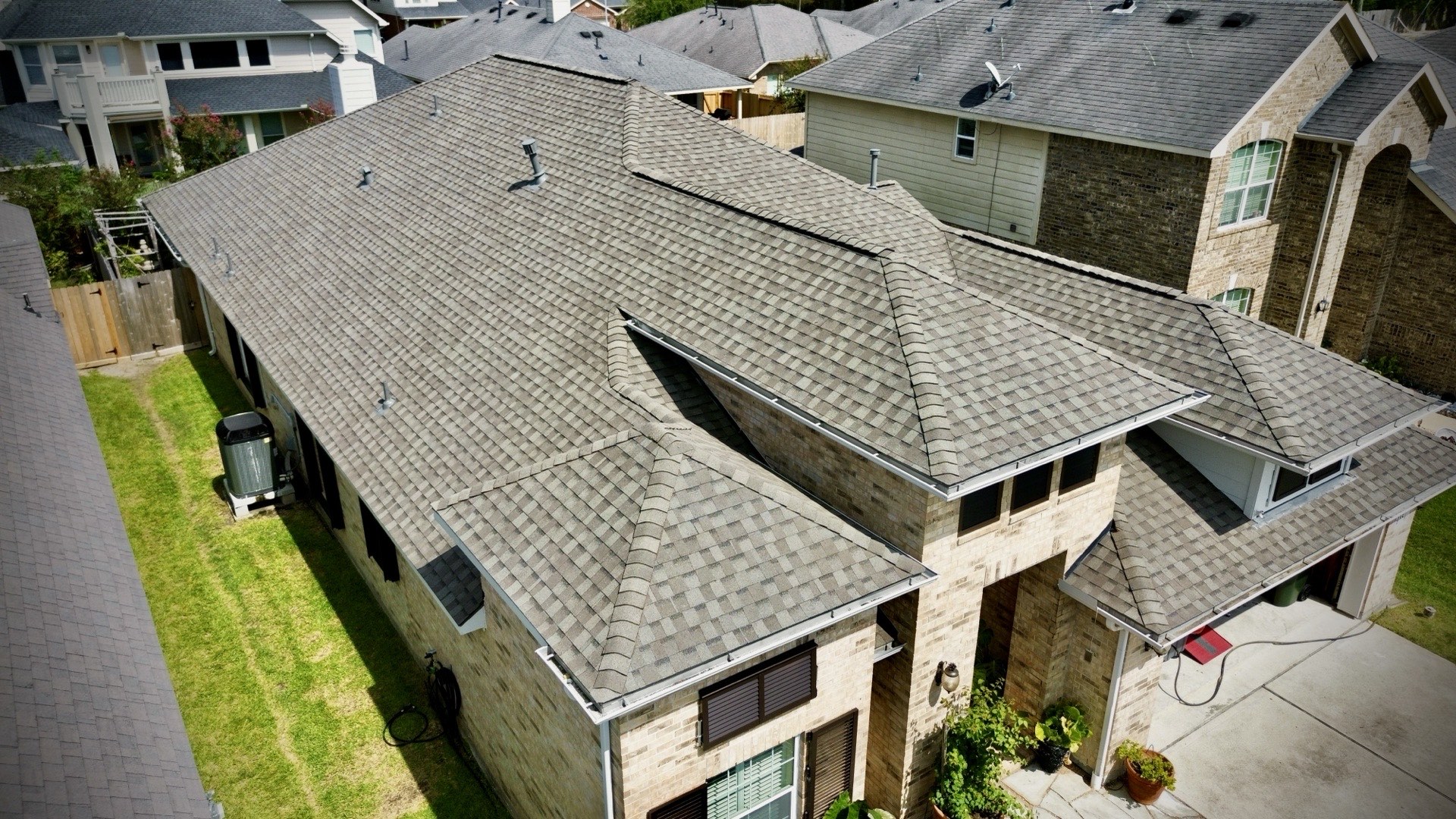 Aerial view of a completed shingle roof repair by Recon Roofing